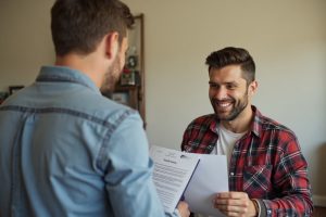 Homeowner discussing furnace replacement financing with an HVAC technician